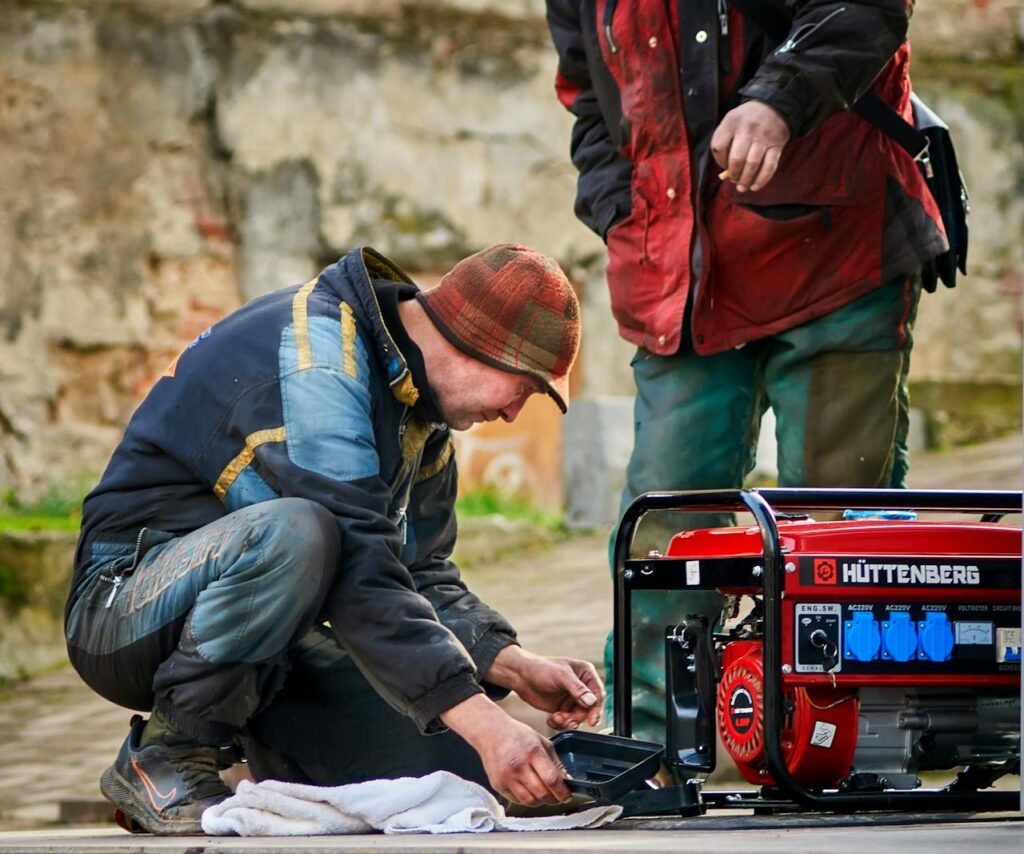The Art of Drawing Readers In: Your attractive post title goes here Two technicians working on a red HÜTTENBERG power generator outdoors.